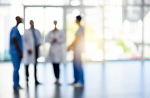 Blurred shot of a team of doctors standing together in a hospital