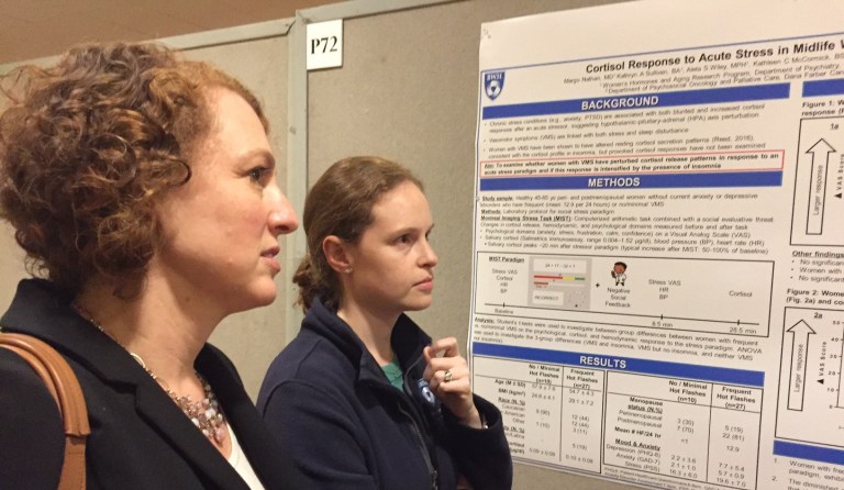 women review research posters at the Brigham