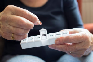 Senior Woman Taking Medication From Pill Box