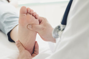 Doctor giving a patient foot treatment