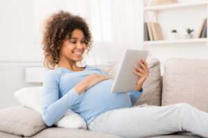 pregnant woman sitting on couch
