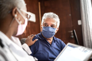 Masked doctor and patient