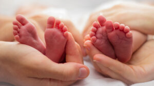 two pairs of newborn feet