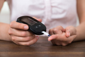 Person doing finger prick for diabetes