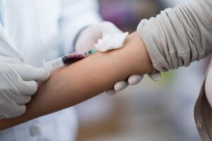 Provider drawing blood from patient