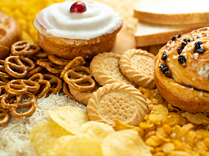 Close up of processed foods like pretzels, cookies, potato chips