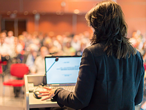 Woman presenting slides at a conference
