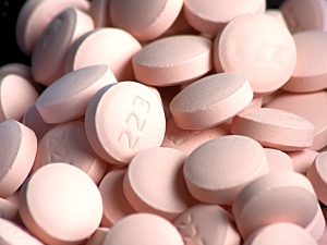Close up of a pile of pink lithium tablets with "223" imprinted on one side