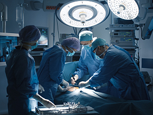 Medical team works in modern operating room performing cardiac surgery