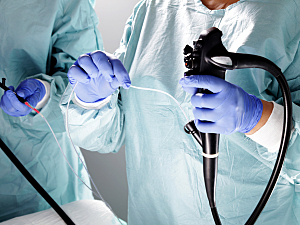 Surgeons holding endoscopic tools preparing for gastrointestinal evaluation