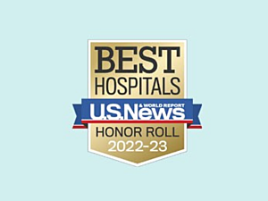 Gold and blue U.S. News and World Report Best Hospitals Honor Roll 2022-23 badge on blue background