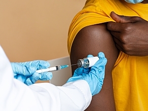Doctor In Blue Medical Gloves Taking Dose Of Vaccine From Vial With Syringe