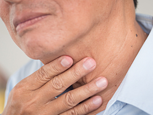Close up of older man touching throat, discomfort, inducible laryngeal obstruction concept